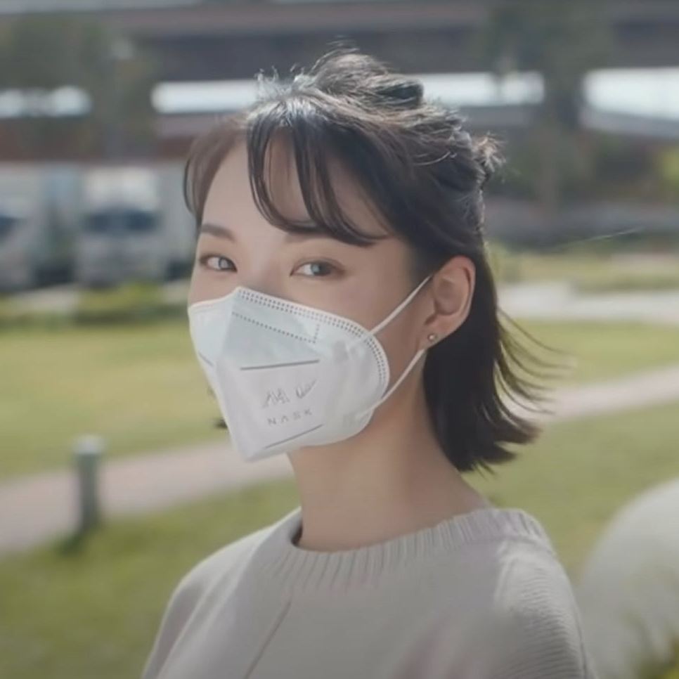 A girl is wearing NASK respirators